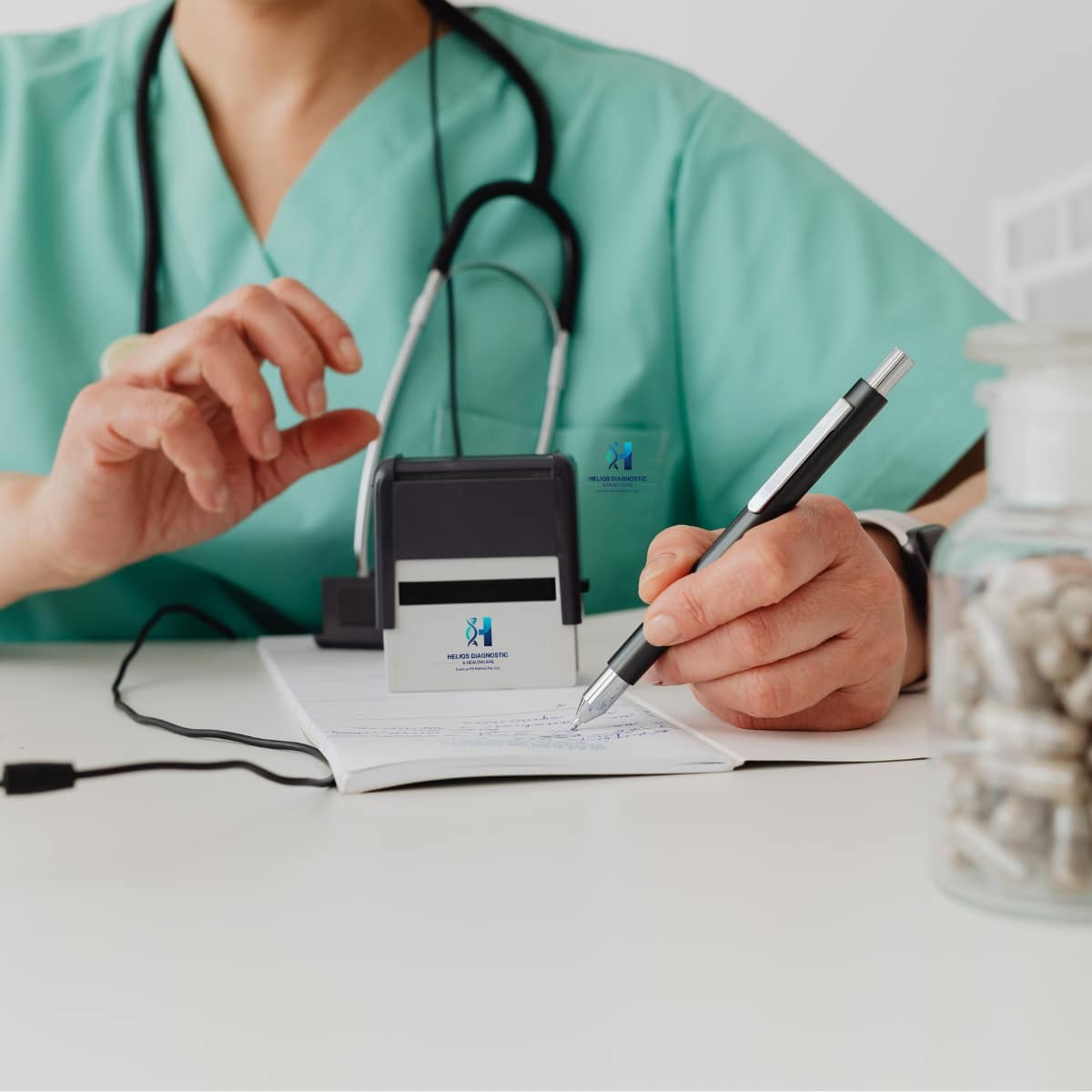 A healthcare professional in green scrubs with a stethoscope, using a stamp and pen to authorize medical documents or prescriptions.